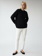 Oversized cable-knit crewneck sweater with dropped shoulders and diamond rope pattern