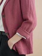 Cotton-linen blazer with relaxed fit, notch lapels, two-button closure, and natural textured fabric