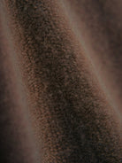 Woman wearing oversized polo knit loungewear set with V-neck collar and straight-leg pants