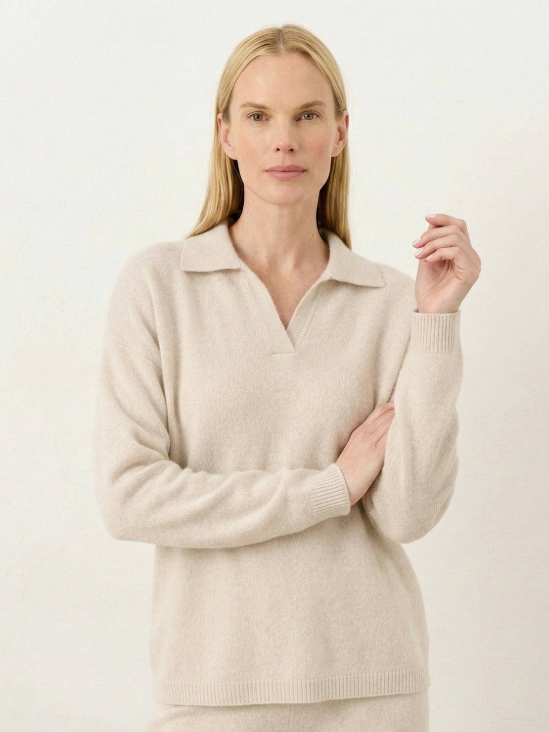 Woman wearing oversized polo knit loungewear set with soft V-neck collar and straight-leg pants