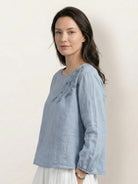 Hip-length cotton-linen embroidered blouse with 3/4 balloon sleeves and gathered cuffs in relaxed boxy fit.