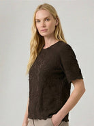 Floral jacquard pleated top with 3D floral texture, flutter sleeves, and relaxed A-line fit