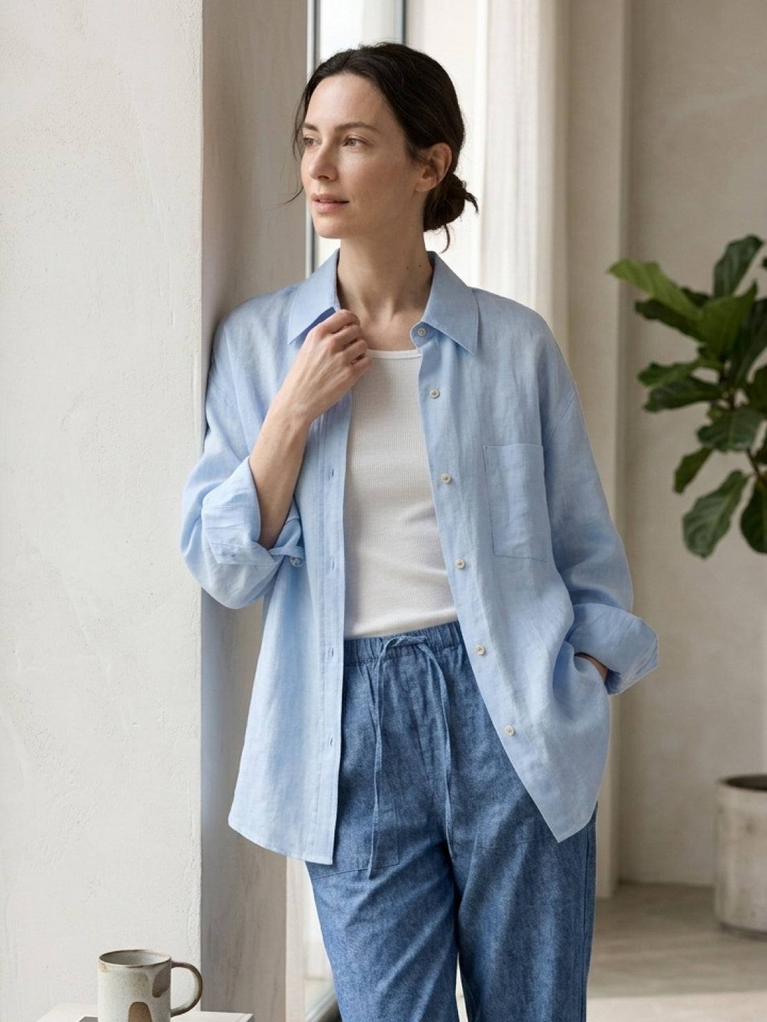 Woman wearing 100% linen oversized dropped-shoulder shirt with rolled sleeves and side slits