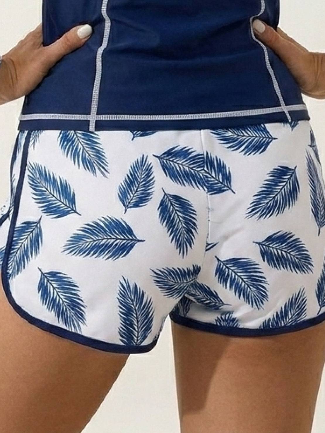 Long-sleeve UV rash guard set with tropical print sleeves and matching swim shorts for sun protection and sporty style