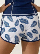 Long-sleeve UV rash guard set with tropical print sleeves and matching swim shorts for sun protection and sporty style