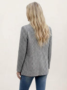Black and white houndstooth commuter blazer with structured shoulders and relaxed fit