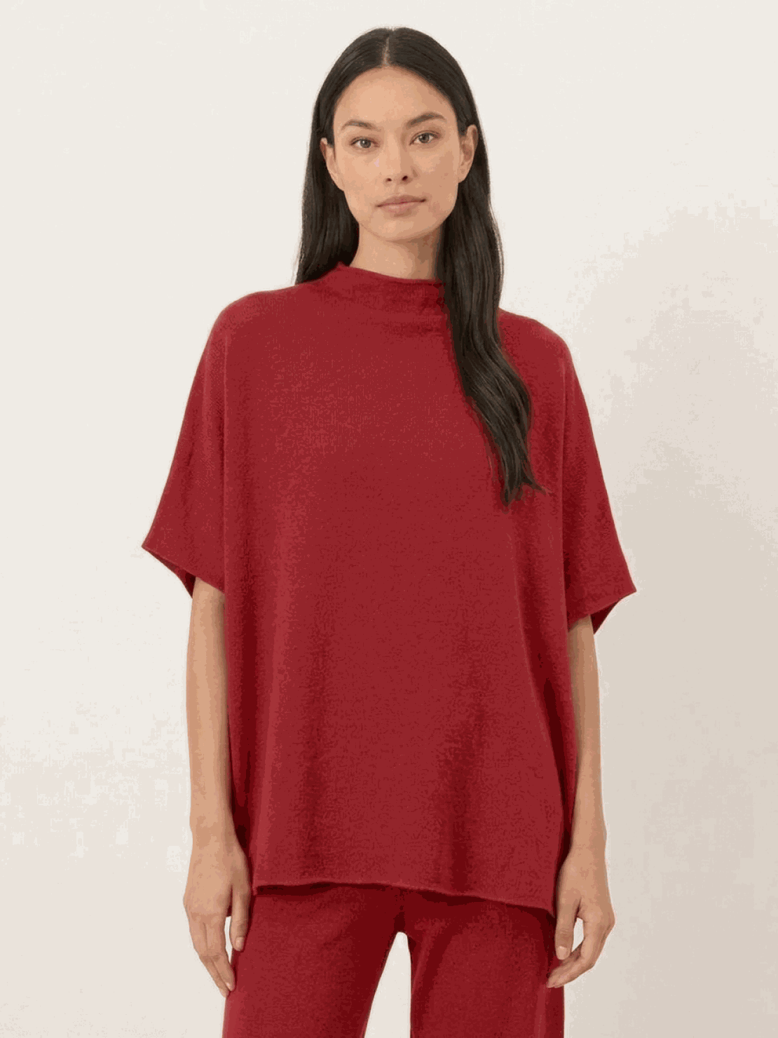 Woman wearing cotton-blend capelet top with batwing sleeves and wide-leg pants lounge set in mauve