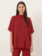 Woman wearing cotton-blend capelet top with batwing sleeves and wide-leg pants lounge set in mauve