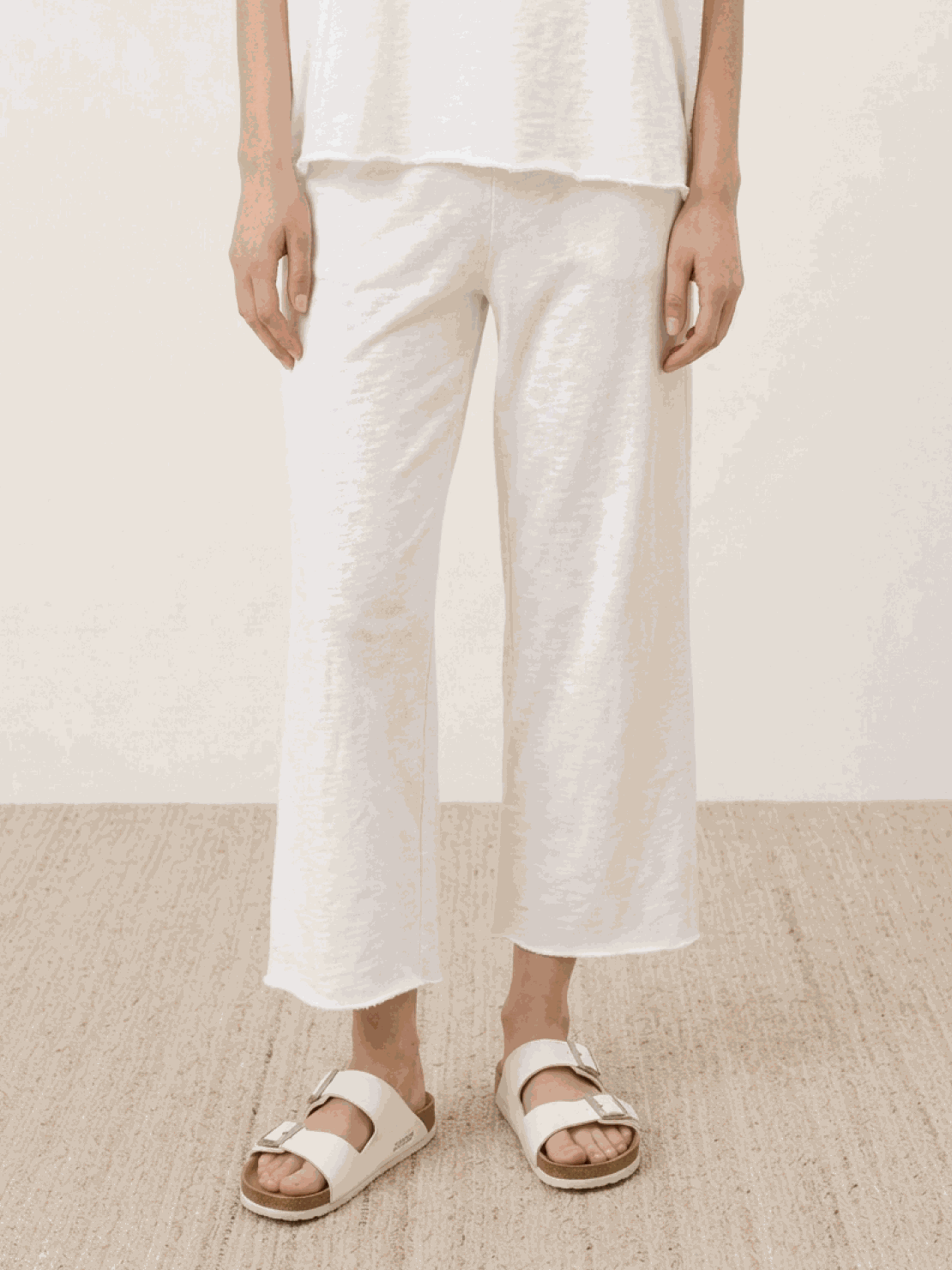Woman wearing a cotton-blend capelet top with batwing sleeves and wide-leg pants lounge set in chocolate brown