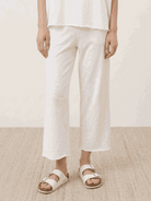Woman wearing a cotton-blend capelet top with batwing sleeves and wide-leg pants lounge set in chocolate brown