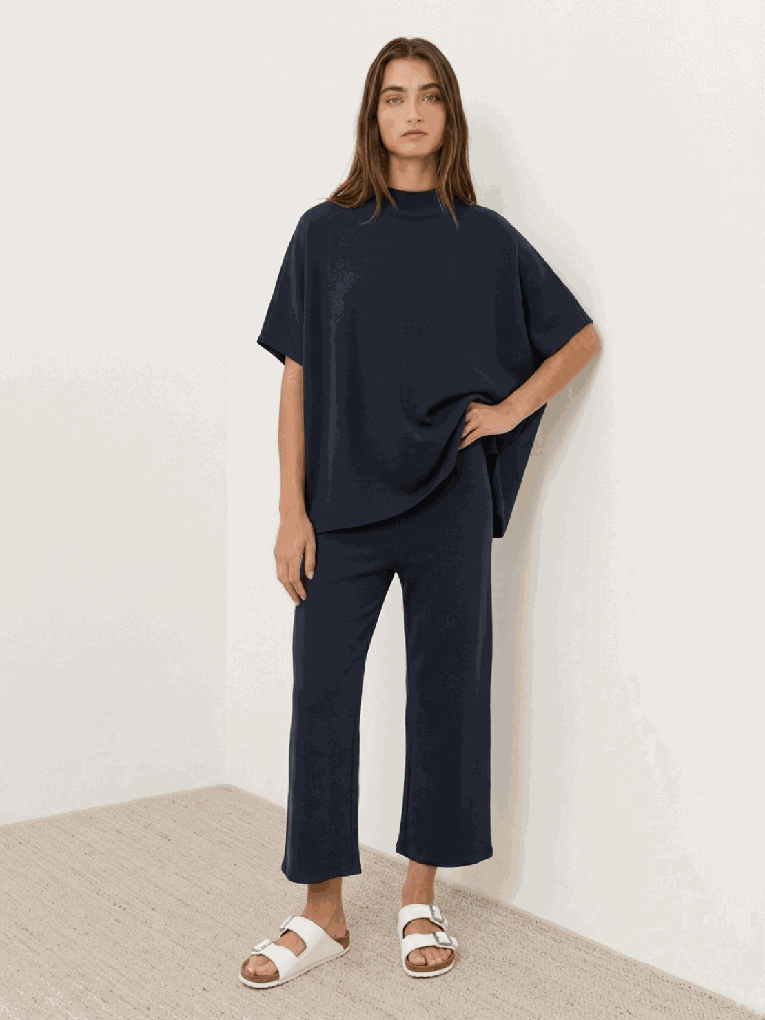 Woman wearing cotton-blend capelet top with batwing sleeves and wide-leg pants lounge set in mauve