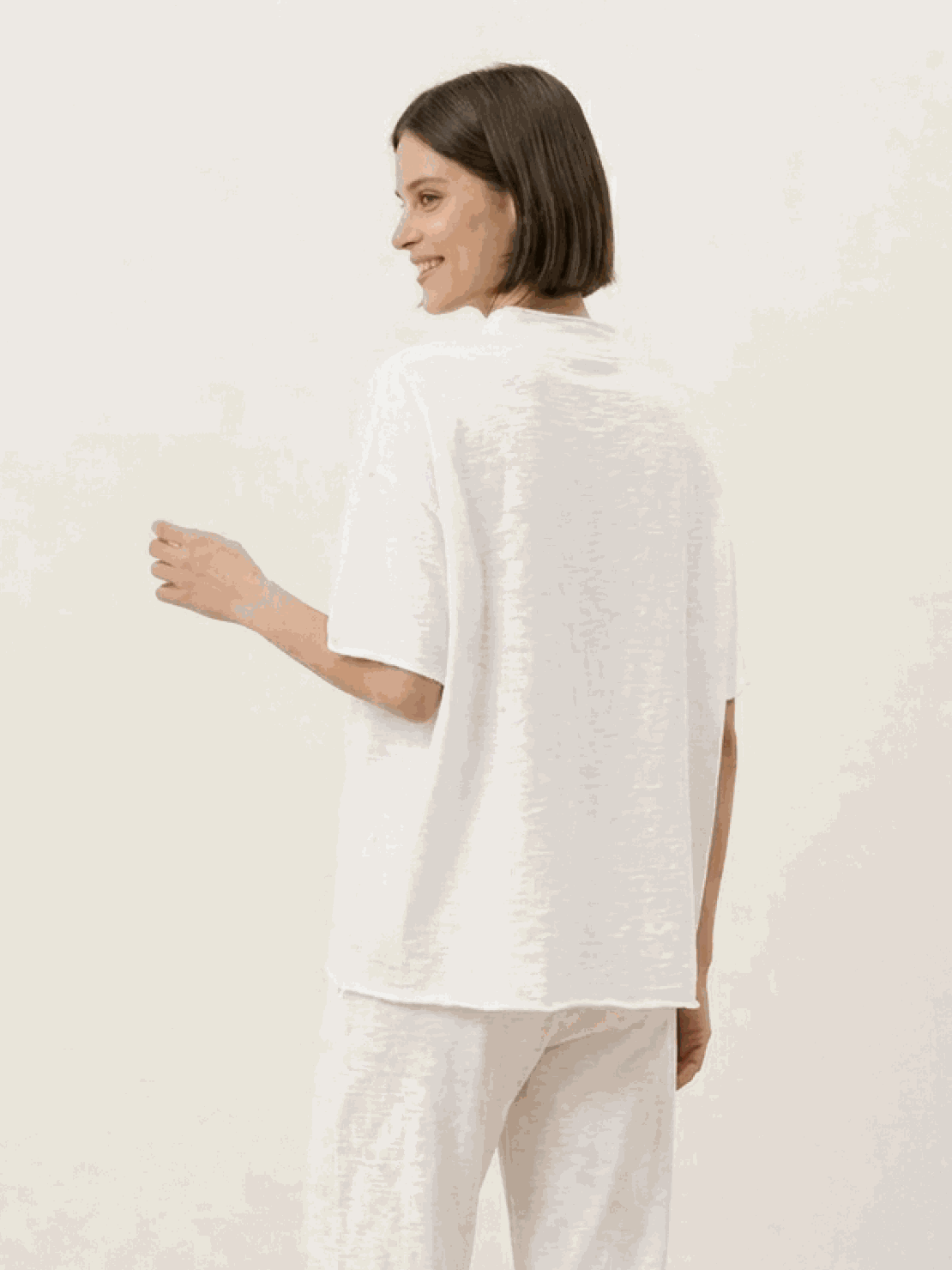 Woman wearing a chocolate brown cotton-blend capelet lounge set with batwing sleeves and wide-leg pants