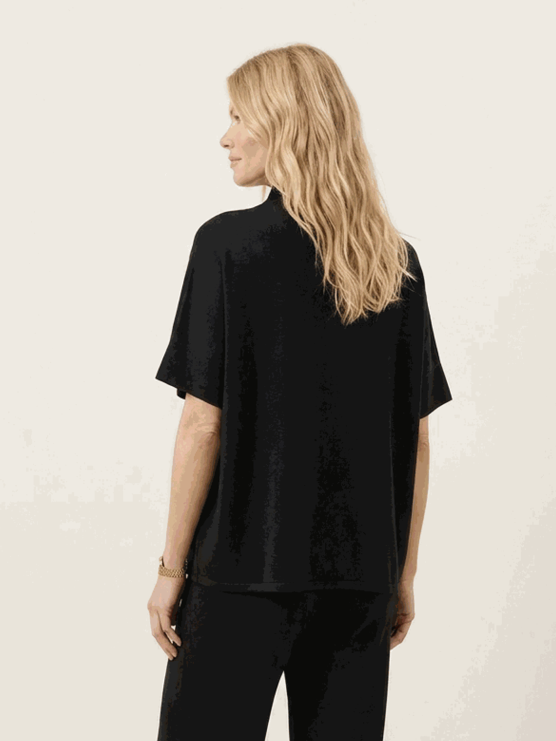 Woman wearing chocolate brown cotton-blend capelet top with batwing sleeves and cropped wide-leg pants lounge set