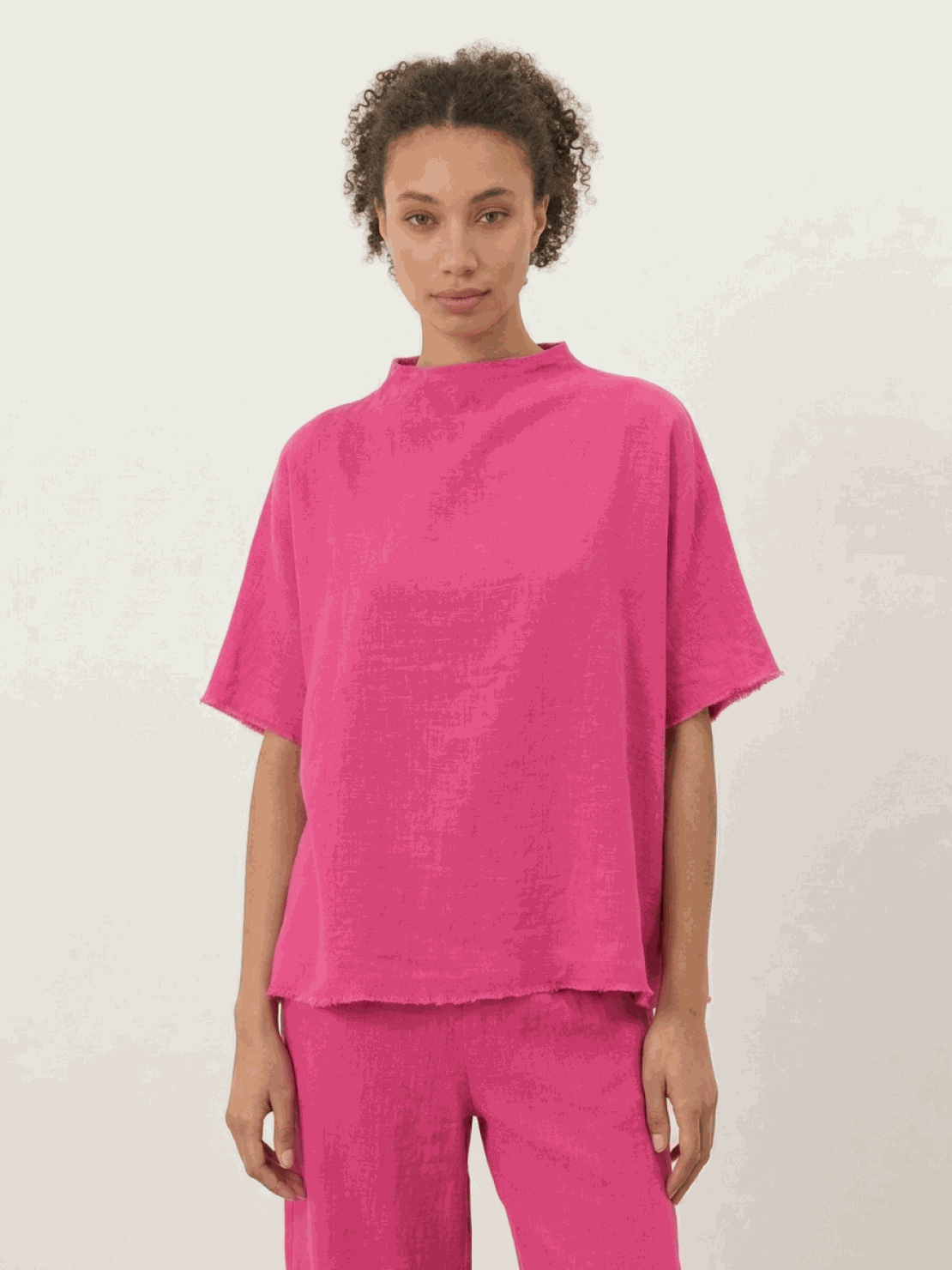 Woman wearing a cotton-blend capelet top with batwing sleeves and wide-leg pants lounge set in chocolate brown