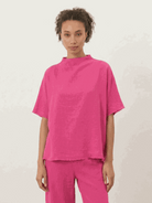 Woman wearing a cotton-blend capelet top with batwing sleeves and wide-leg pants lounge set in chocolate brown