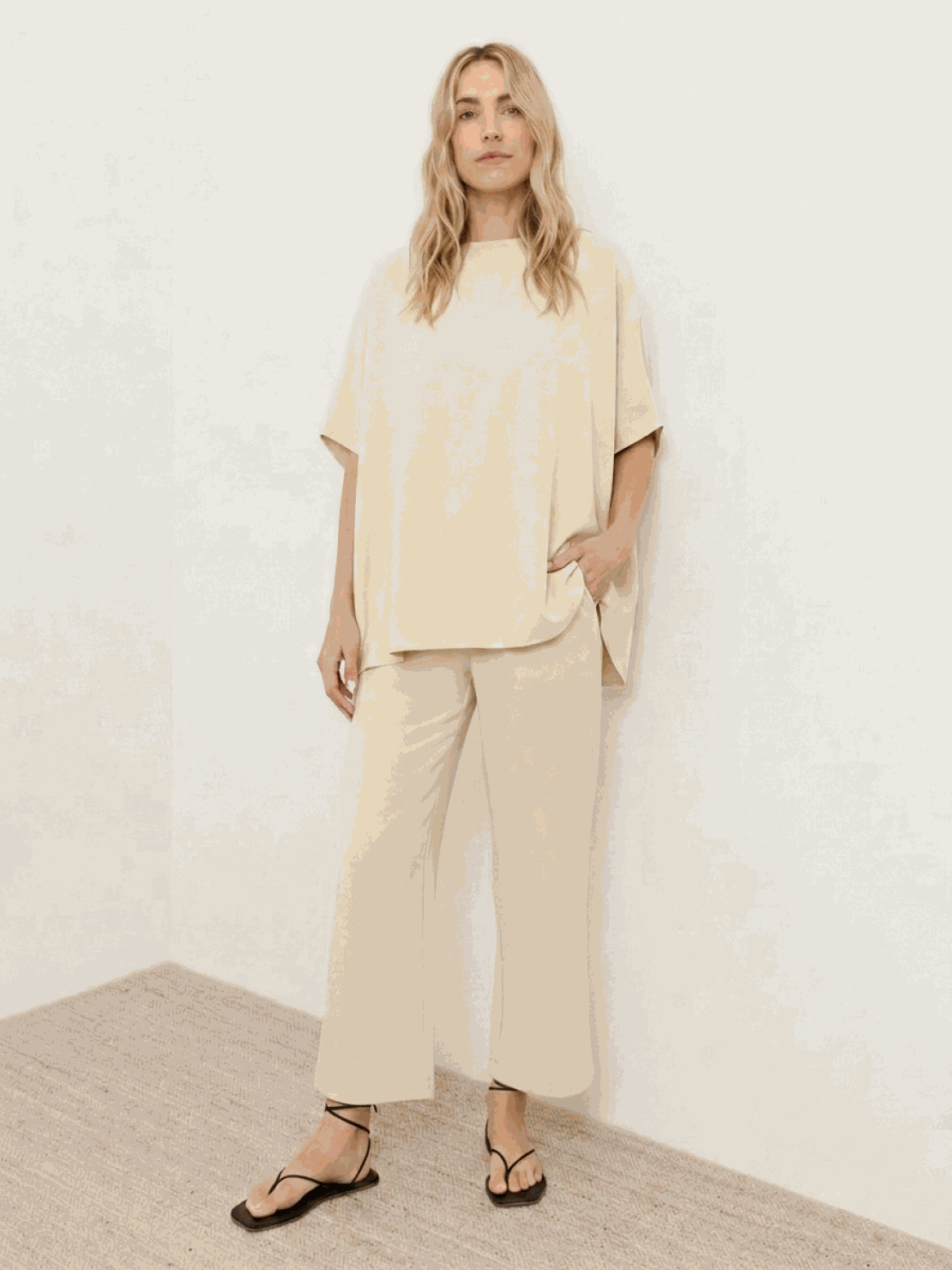 Woman wearing a chocolate brown cotton-blend capelet top with batwing sleeves and wide-leg pants lounge set