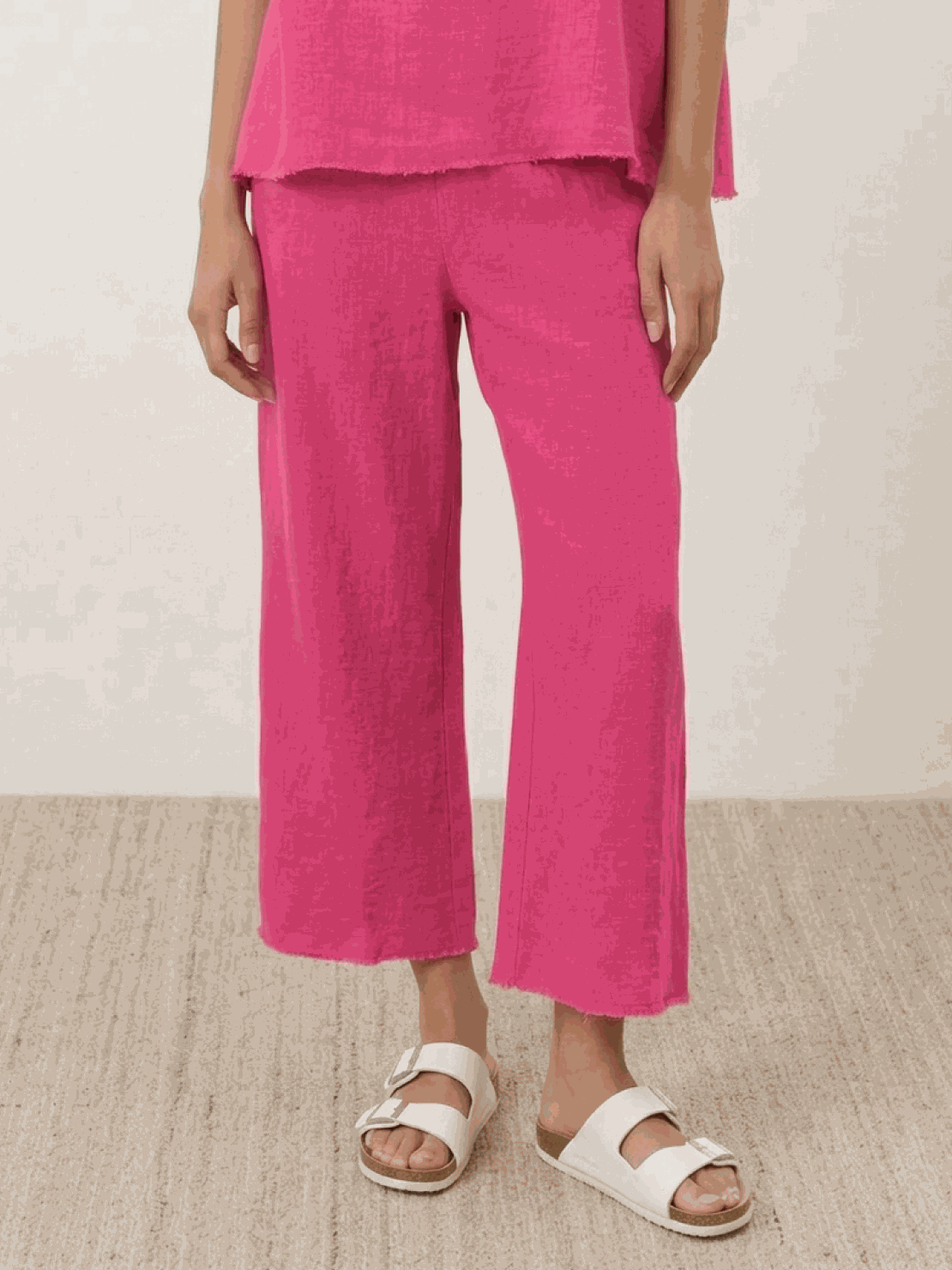 Woman wearing chocolate brown cotton-blend capelet top with batwing sleeves and cropped wide-leg pants lounge set