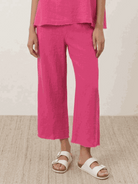 Woman wearing chocolate brown cotton-blend capelet top with batwing sleeves and cropped wide-leg pants lounge set