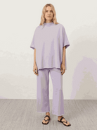 Cotton-blend capelet lounge set with mock neck batwing top and wide-leg pants in neutral tones