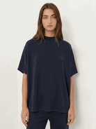 Woman wearing cotton-blend capelet top with wide-leg pants lounge set in chocolate brown