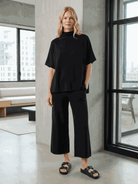 Woman wearing cotton-blend capelet top with batwing sleeves and wide-leg pants lounge set in chocolate brown