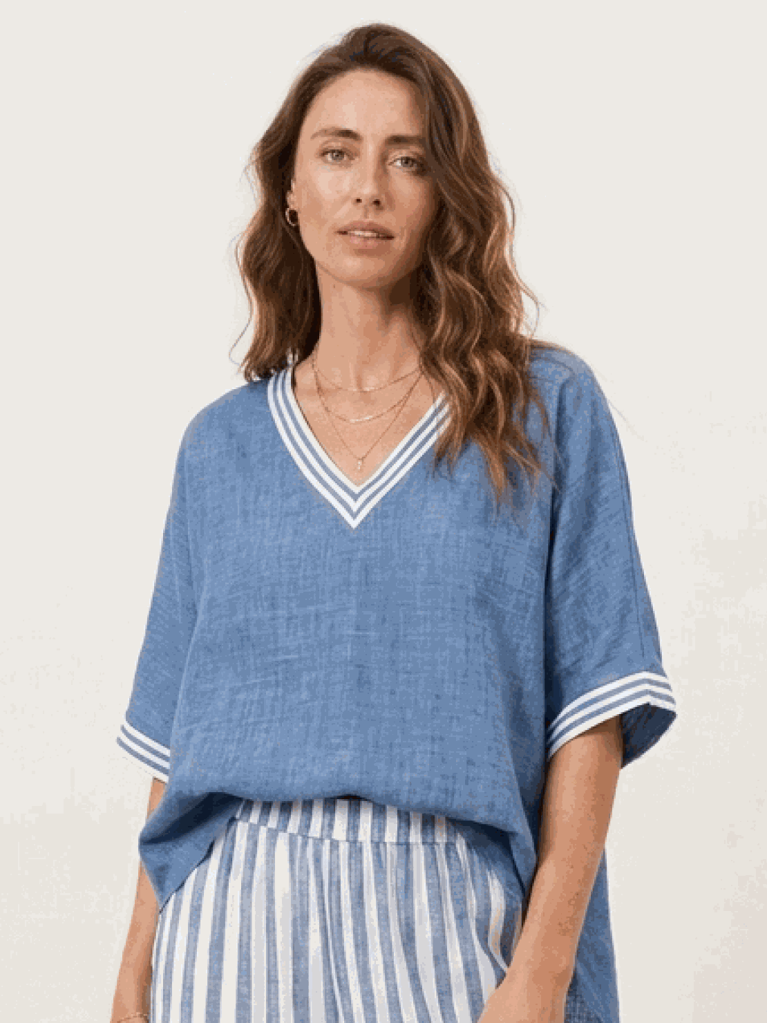 Woman wearing a striped wide-leg co-ord set with oversized top and palazzo pants with elastic waistband and side pockets