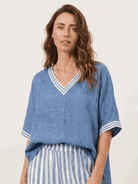 Woman wearing a striped wide-leg co-ord set with oversized top and palazzo pants with elastic waistband and side pockets