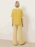 Woman wearing striped wide-leg co-ord set with oversized top and palazzo pants in multiple colors
