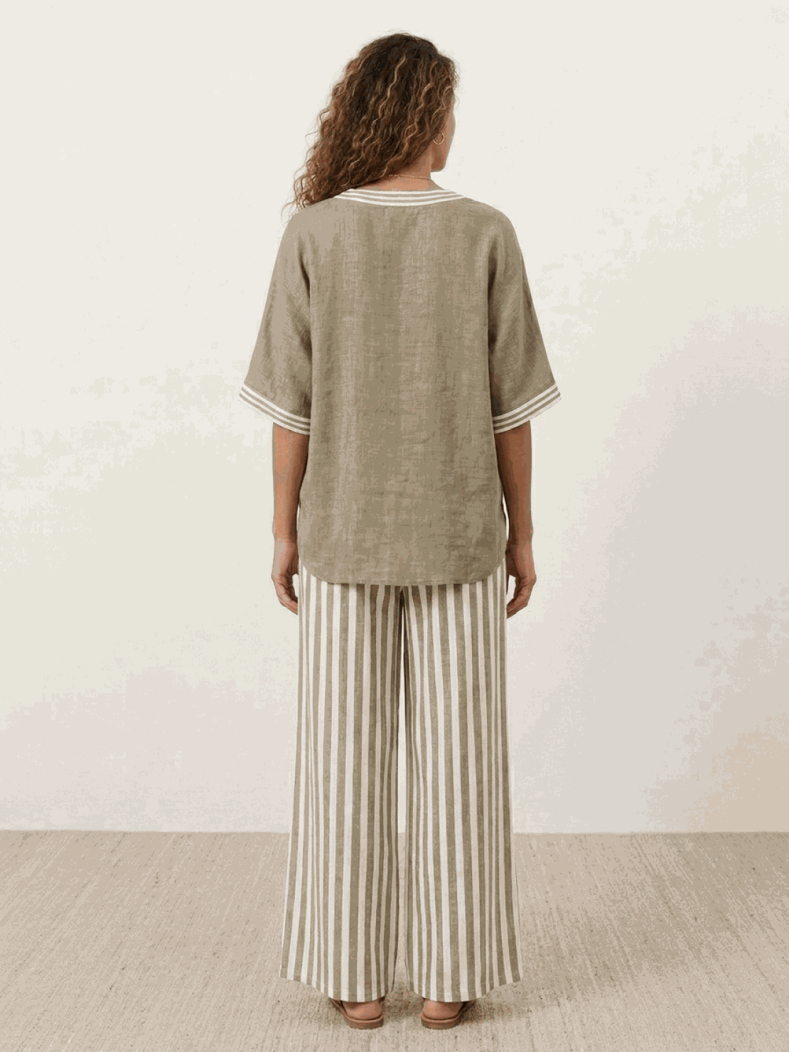 Woman wearing striped wide-leg co-ord set with oversized top and palazzo pants in multiple colors