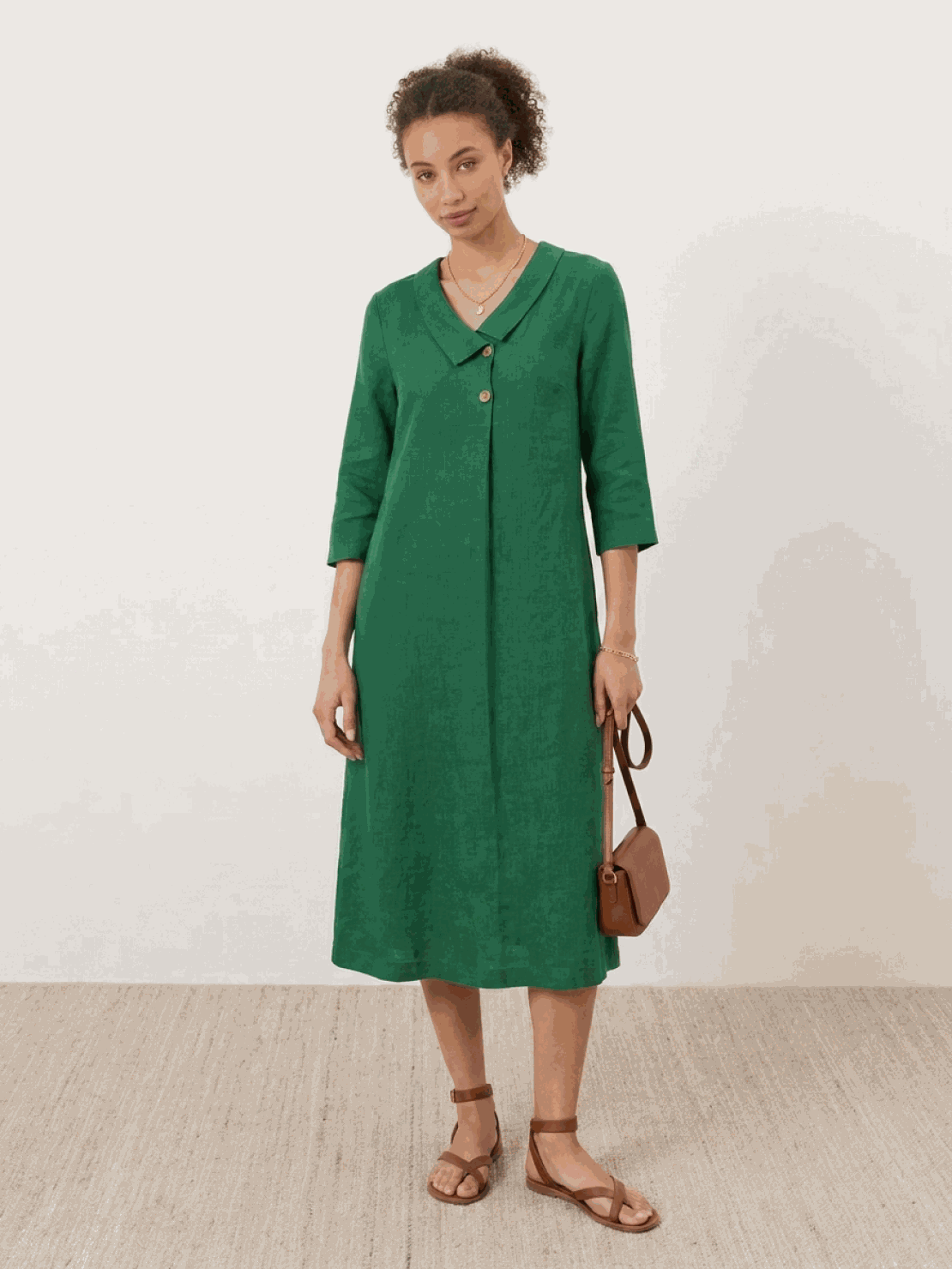 Woman wearing a navy linen-look midi dress with 3/4 sleeves and side pockets