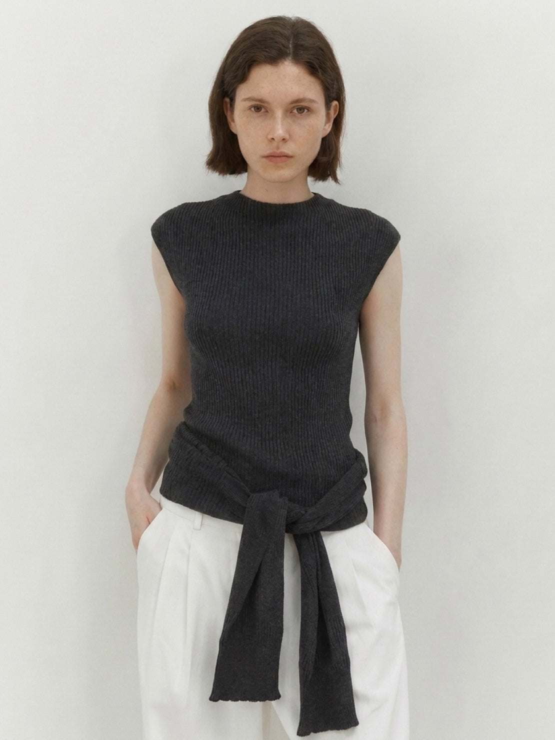 Knit vest with attached scarf in fine ribbed knit showcasing versatile styling options