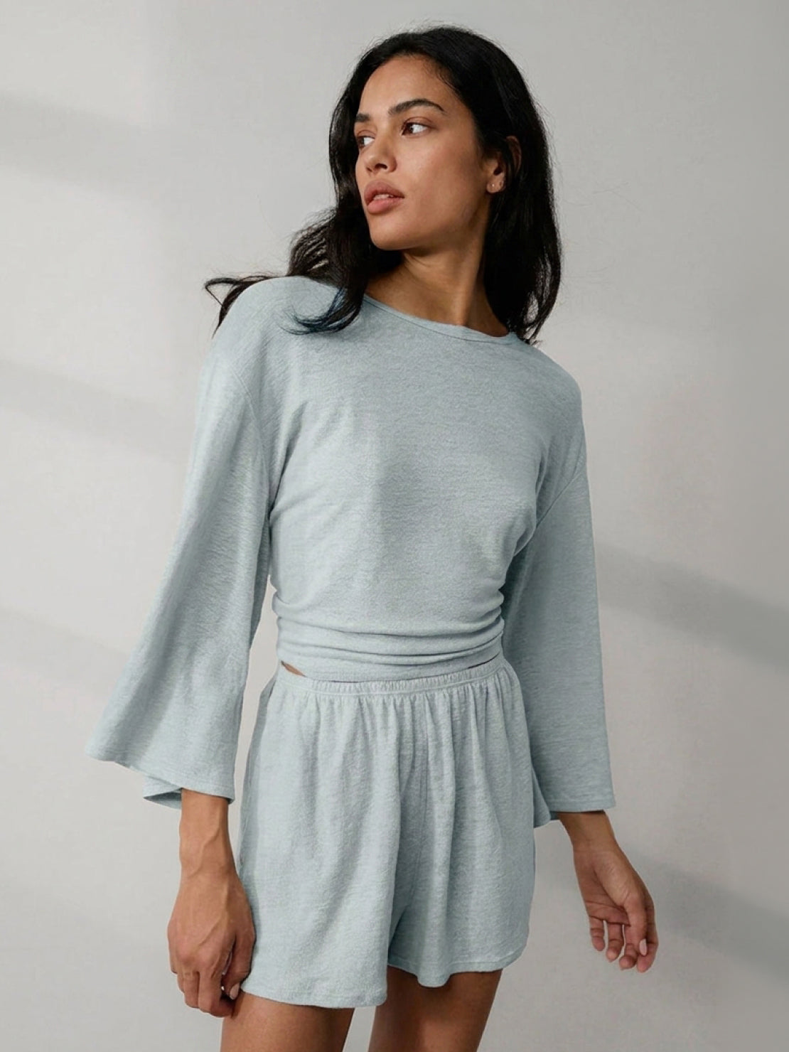 Light blue linen blend lounge set with cropped top and bell sleeves, styled for comfort and breathability