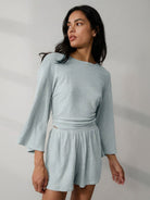 Light blue linen blend lounge set with cropped top and bell sleeves, styled for comfort and breathability