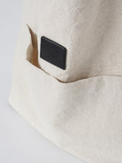 Beige cotton linen canvas shoulder bag with front pocket and comfortable straps for everyday use