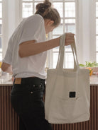 Beige cotton linen canvas shoulder bag with front pocket and comfortable straps for everyday use
