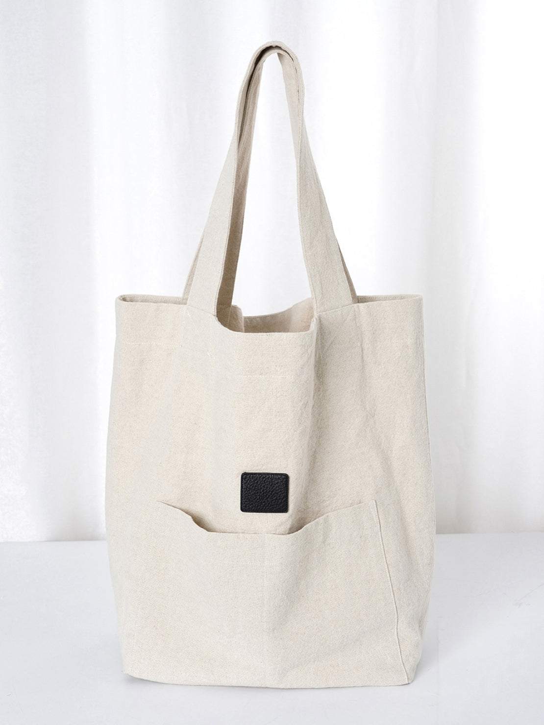 Beige cotton linen canvas shoulder bag with roomy interior and front pocket for everyday use