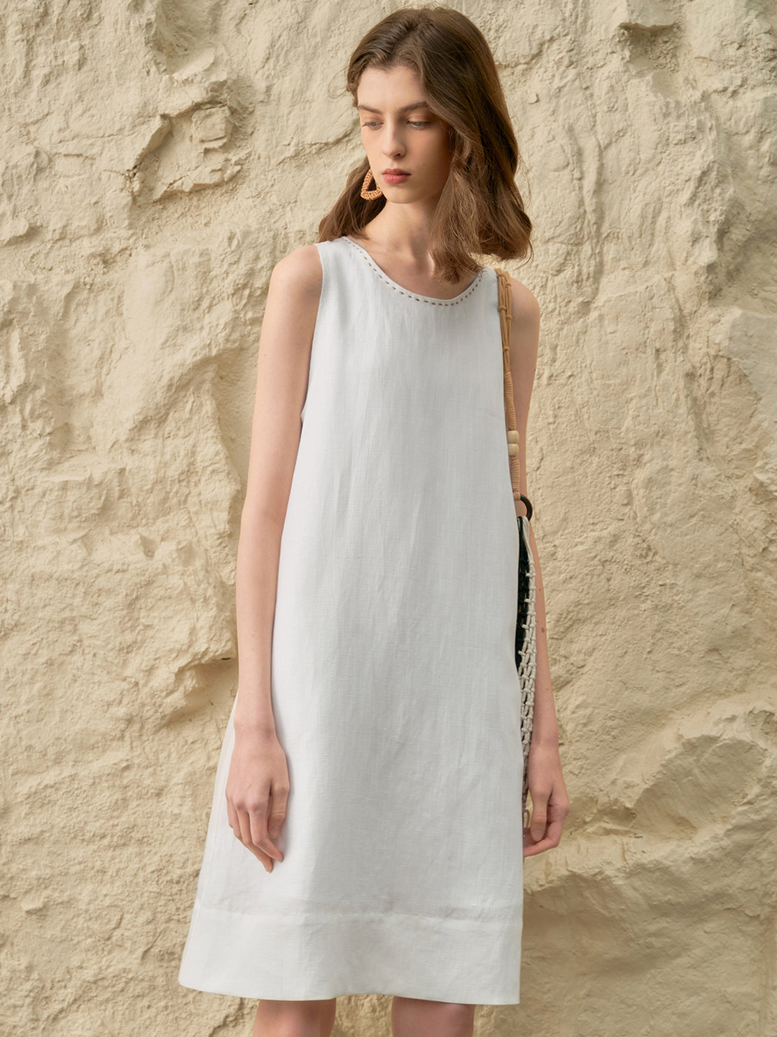 Sleeveless Linen Lyocell blend dress in relaxed A-line silhouette with hand-stitched neckline detail
