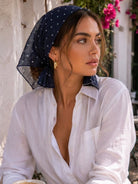 Lightweight 100% linen neck scarf with checkered pattern, versatile styling options, and natural rolled edges.