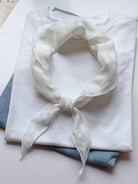 Lightweight 100% linen neck scarf with checkered pattern and natural rolled edges, styled on a white background