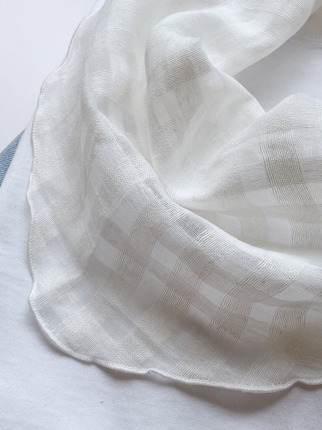 Lightweight 100% linen neck scarf with checkered pattern and rolled edges for versatile styling