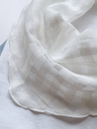 Lightweight 100% linen neck scarf with checkered pattern and rolled edges for versatile styling