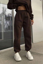 woman wearing cotton-blended two-piece tracksuit with high collar and zipper, monochrome athleisure outfit