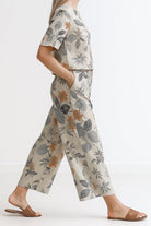 Woman wearing Breezy Meadow Two-Piece Set with relaxed fit top and wide-leg trousers in lightweight fabric