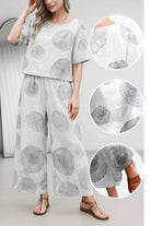 woman wearing Breezy Meadow two-piece set with relaxed top and wide-leg trousers in light fabric