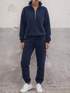 Cotton-blended two-piece tracksuit with high collar, zip front, relaxed fit, and straight-leg pants