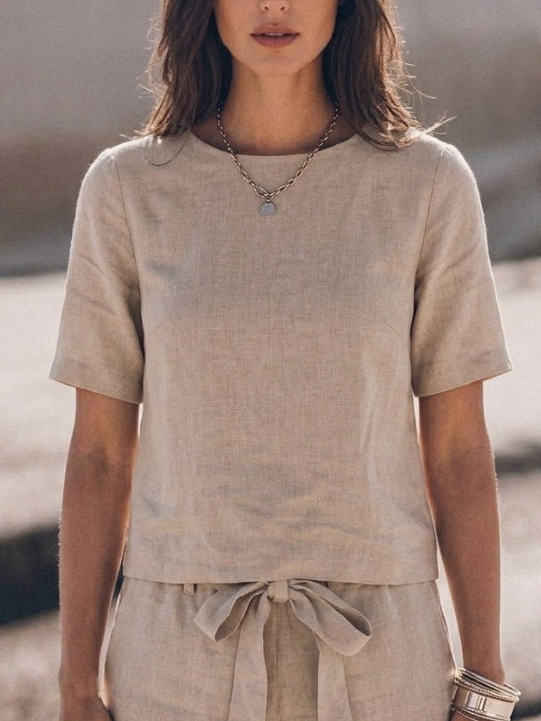 Woman wearing relaxed cotton linen set with short sleeve top and straight-leg pants in monochrome tones