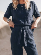 woman wearing relaxed fit cotton linen set with short sleeve top and straight leg pants in monochrome tones
