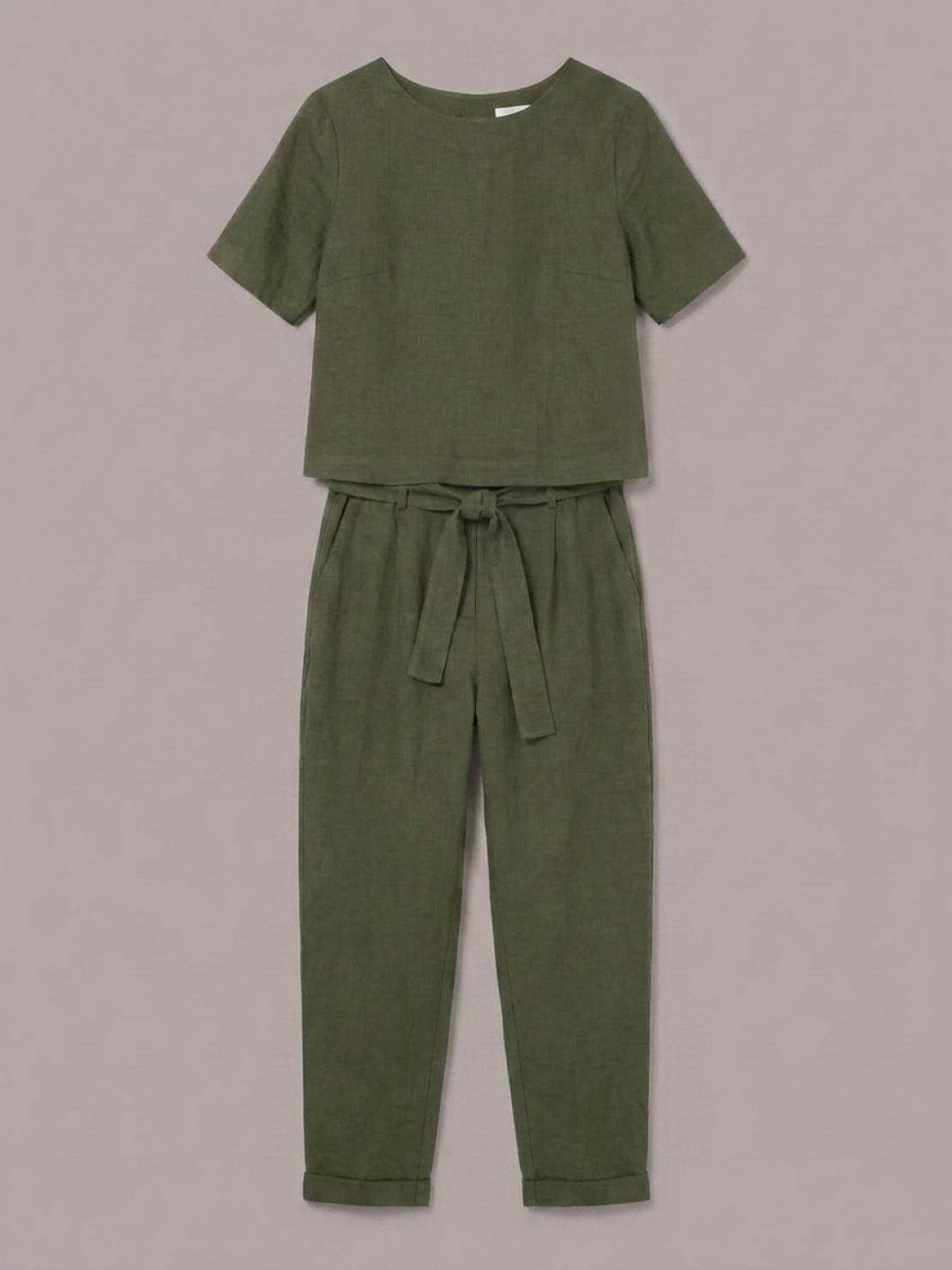 Model wearing a relaxed fit 100% cotton linen set with short-sleeve top and straight-leg pants in monochrome tones