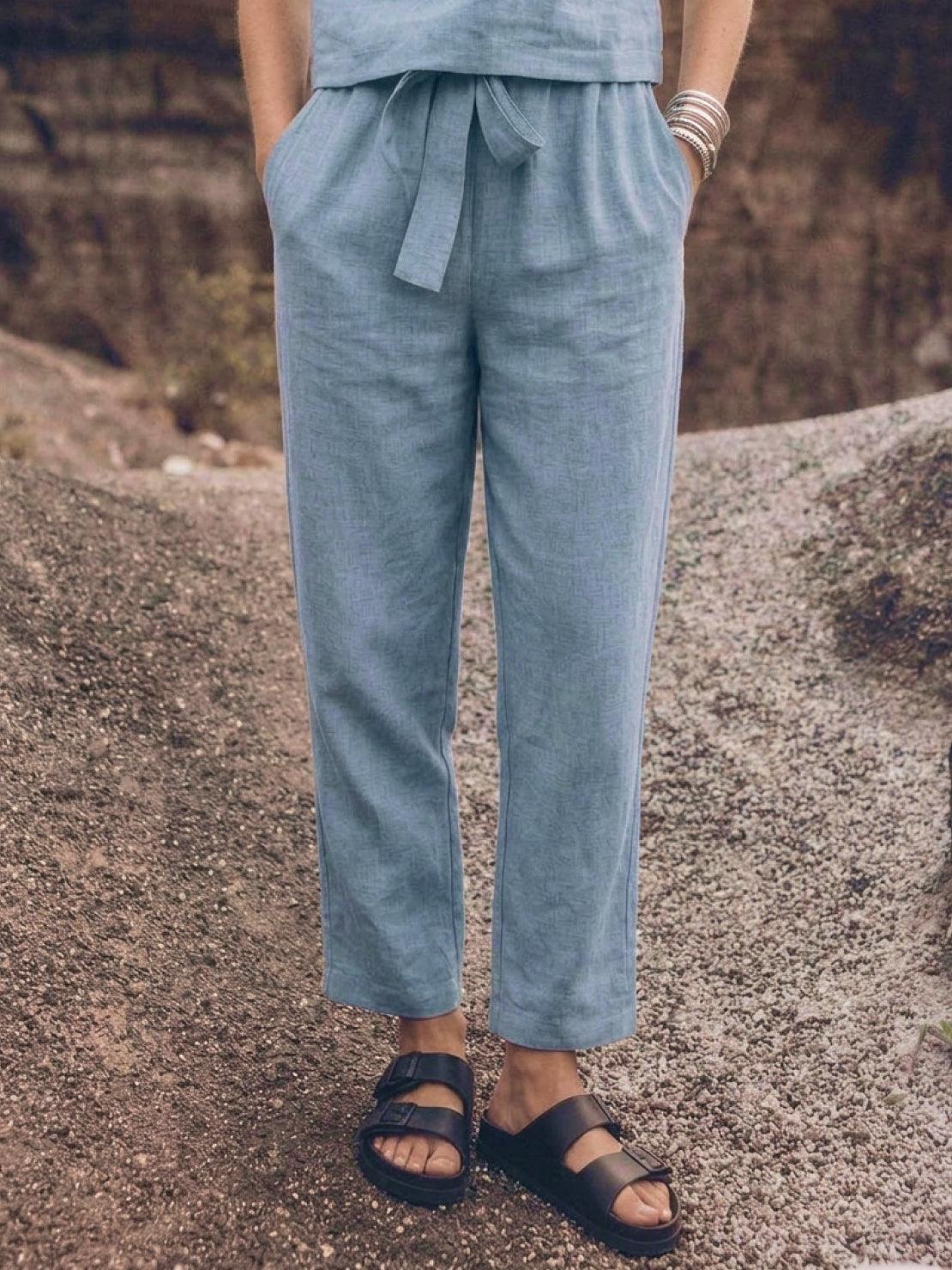 Woman wearing relaxed fit cotton linen set with short-sleeve top and straight-leg pants in monochrome tones