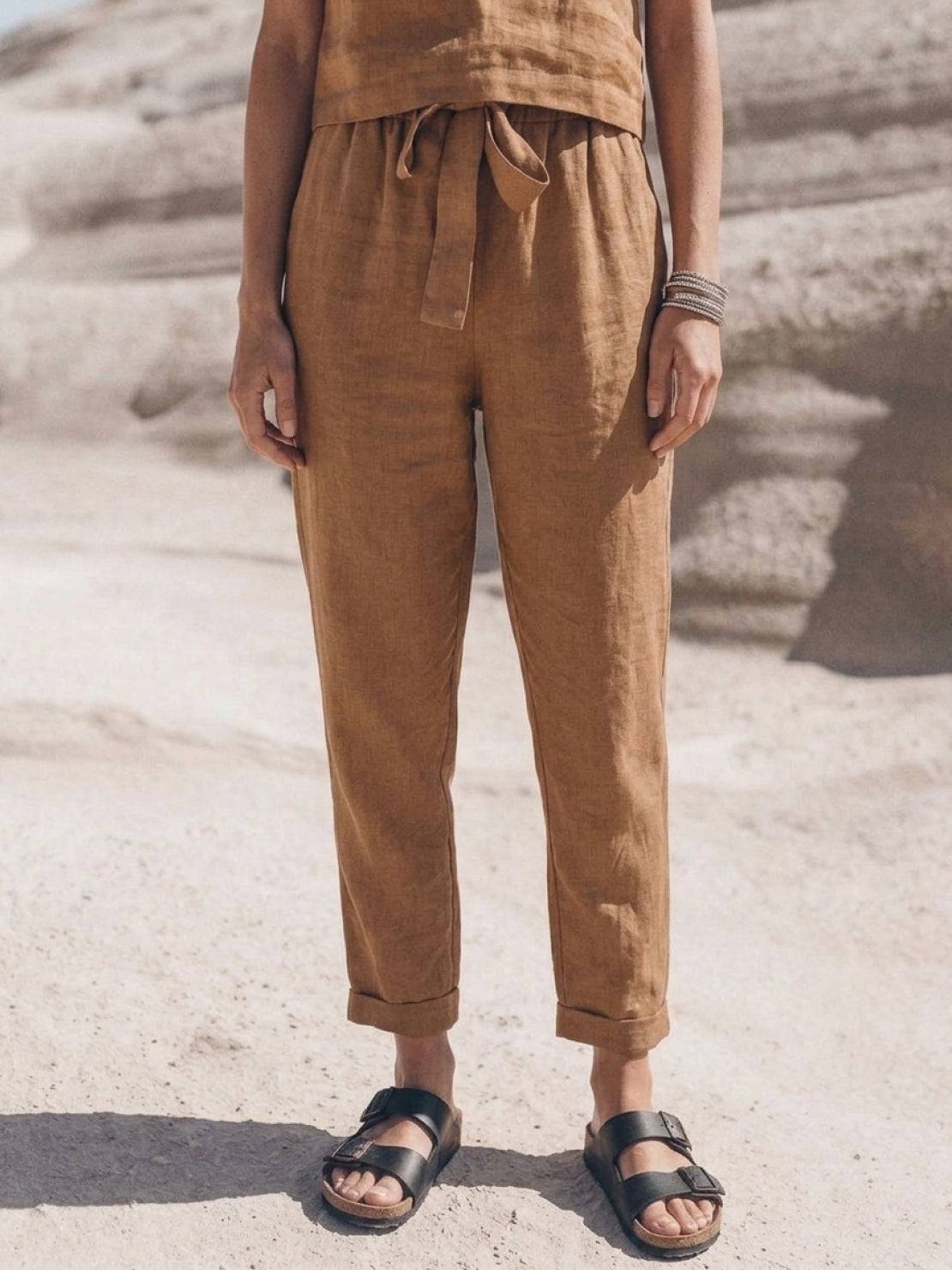 Woman wearing a relaxed cotton-linen monochrome capsule outfit with longline top and wide-leg pants